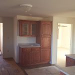 a kitchen with wooden cabinets and a sink in a house .