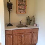 A kitchen with wooden cabinets and a sink.